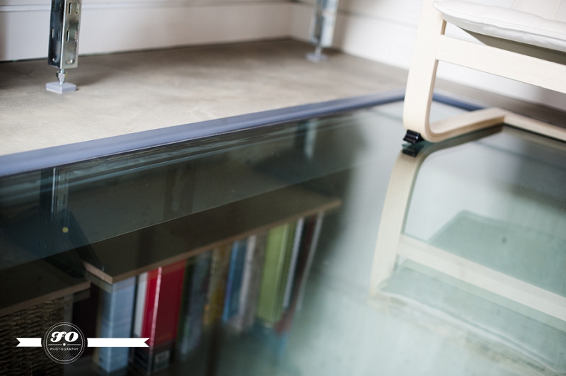 net zero home edmonton, eco friendly house, glass floor in front of bookshelf