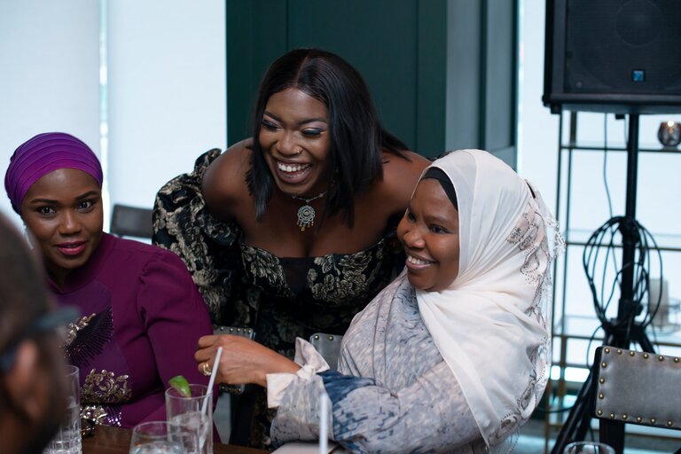 surprise 50th birthday party at Braven in Edmonton. 3 Black women share a laugh.